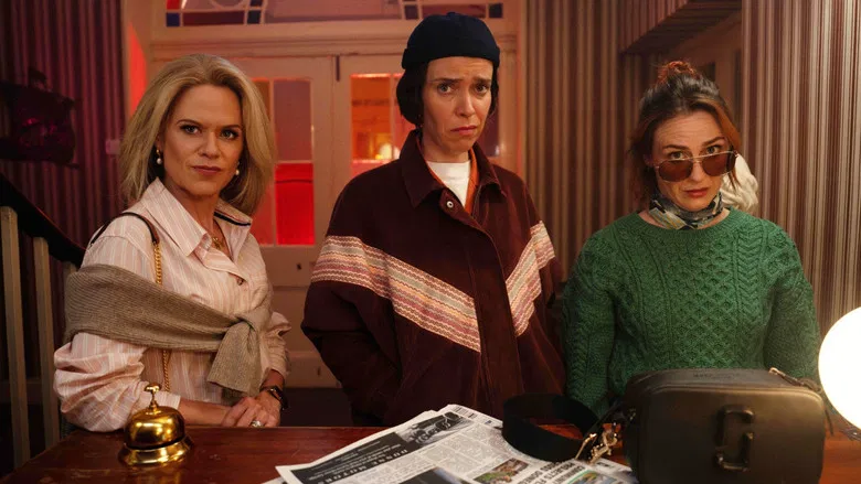 Three friends standing on a bleak Irish coastline